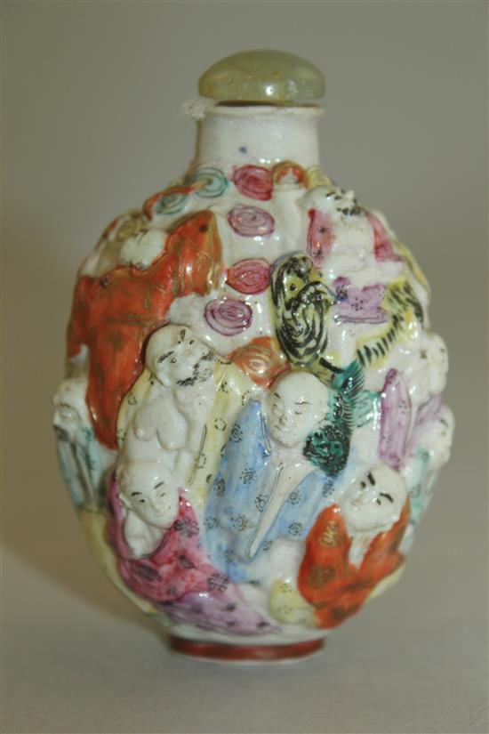 A Chinese moulded famille rose eighteen luohan snuff bottle, Qianlong seal mark, 1820-1850, 7.4cm